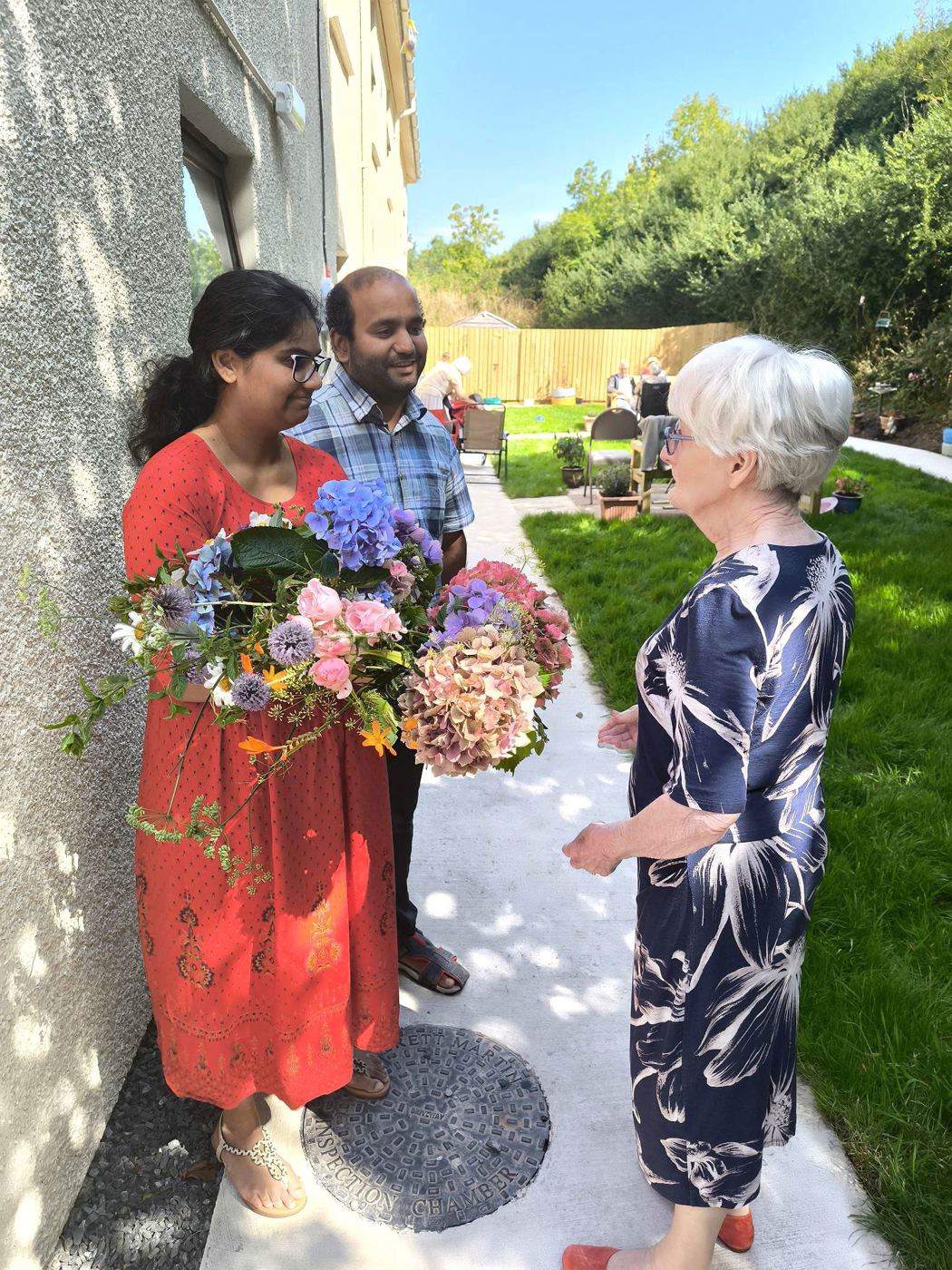 A family visiting with flowers at Rickeston Mill