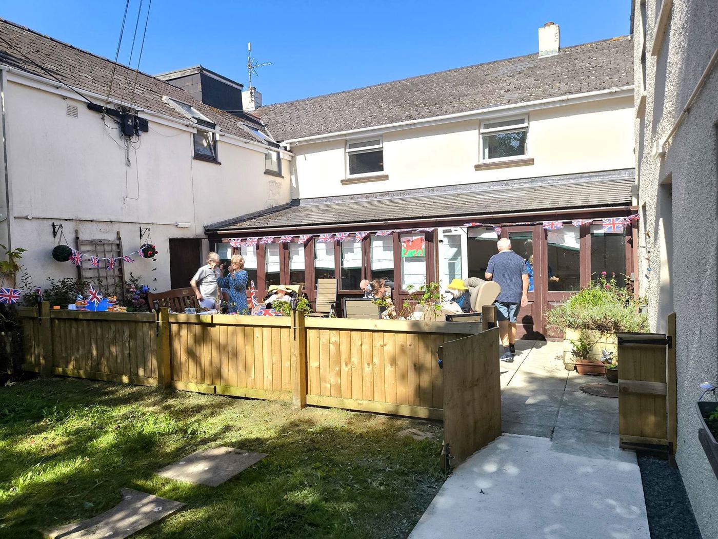 Residents and staff enjoying the patio and gardens at Rickeston Mill